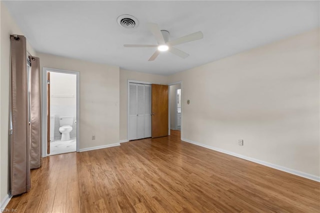 10 Kathy Dr, Poquoson, VA 23662 - unfurnished bedroom with wood finished floors, baseboards, ensuite bath, and a ceiling fan