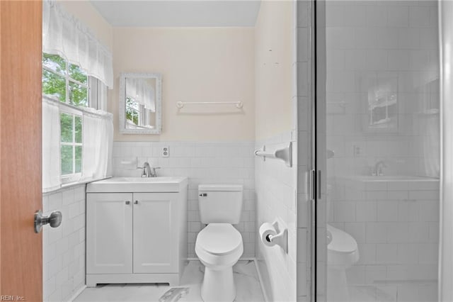 10 Kathy Dr, Poquoson, VA 23662 - bathroom featuring toilet, vanity, a shower stall, wainscoting, and tile walls
