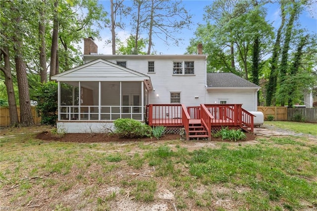 10 Kathy Dr, Poquoson, VA 23662 - back of property with a chimney, a wooden deck, and a sunroom