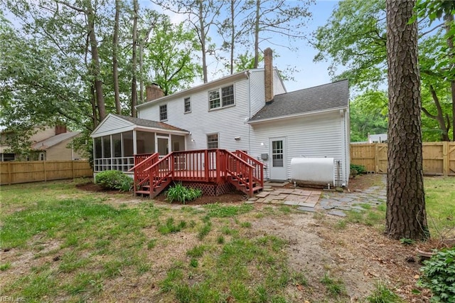 10 Kathy Dr, Poquoson, VA 23662 - back of property with a sunroom, oil tank, a chimney, a deck, and roof with shingles