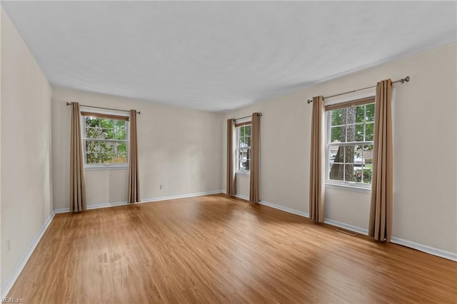10 Kathy Dr, Poquoson, VA 23662 - empty room featuring light wood finished floors, healthy amount of natural light, and baseboards