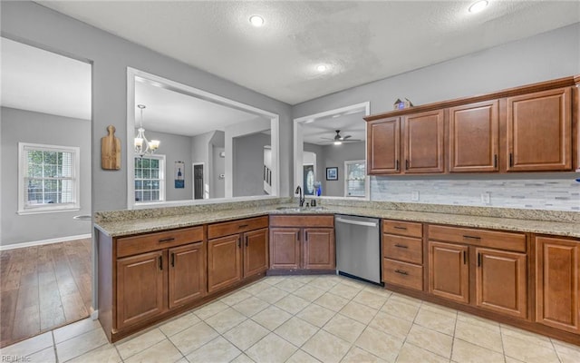 1215 W 27th St, Norfolk, VA 23508 - kitchen featuring dishwasher, a sink, ceiling fan, light stone counters, and a textured ceiling