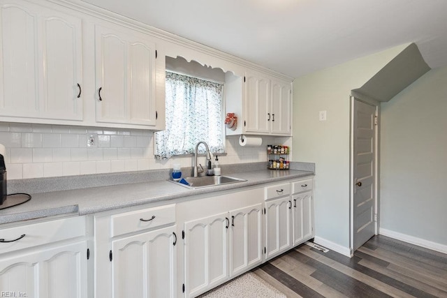 2766 Mckann Ave, Norfolk, VA 23509 - kitchen with a sink, dark wood-type flooring, tasteful backsplash, white cabinets, and baseboards