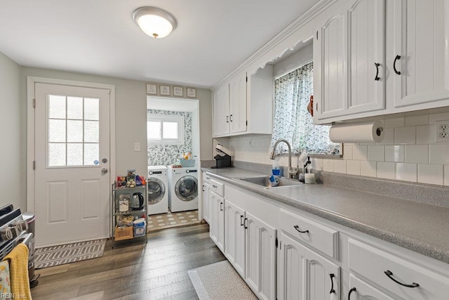 2766 Mckann Ave, Norfolk, VA 23509 - kitchen featuring a sink, independent washer and dryer, gas stove, dark wood-type flooring, and white cabinets