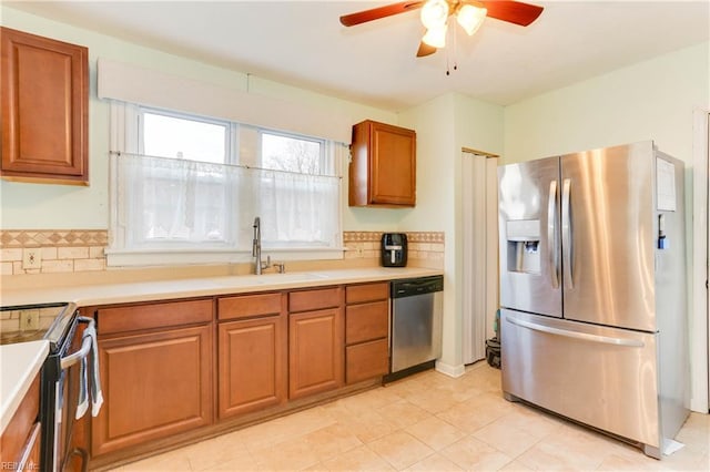 1108 E Pembroke Ave, Hampton, VA 23669 - kitchen featuring stainless steel appliances, a sink, a ceiling fan, and brown cabinets