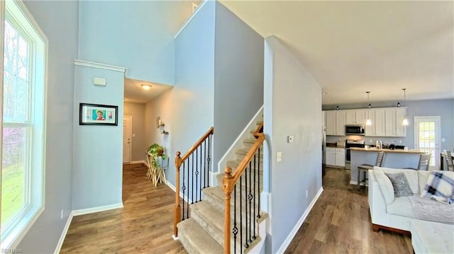 228 Bethune Dr, Williamsburg, VA 23185 - stairs featuring wood finished floors and baseboards
