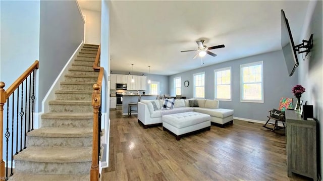 228 Bethune Dr, Williamsburg, VA 23185 - living area featuring ceiling fan, stairs, dark wood-style floors, and baseboards
