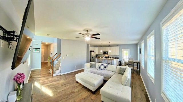 228 Bethune Dr, Williamsburg, VA 23185 - living area with stairway, wood finished floors, baseboards, and ceiling fan