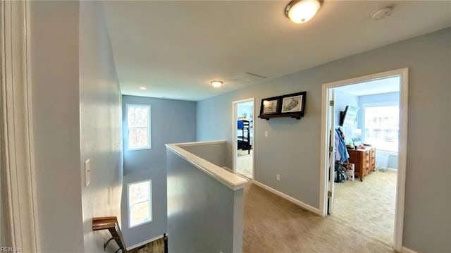 228 Bethune Dr, Williamsburg, VA 23185 - hallway with an upstairs landing, baseboards, and light carpet