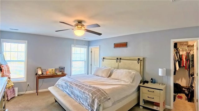 228 Bethune Dr, Williamsburg, VA 23185 - bedroom with a walk in closet, a closet, light carpet, baseboards, and a ceiling fan