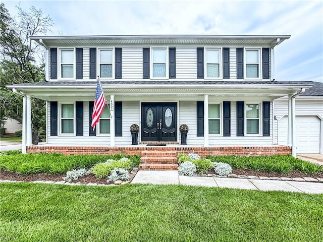 4657 Revere Dr, Virginia Beach, VA 23456 - view of front of property with covered porch, an attached garage, and a front yard