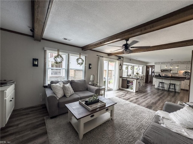 4657 Revere Dr, Virginia Beach, VA 23456 - living room featuring a textured ceiling, dark wood-type flooring, beam ceiling, and a ceiling fan