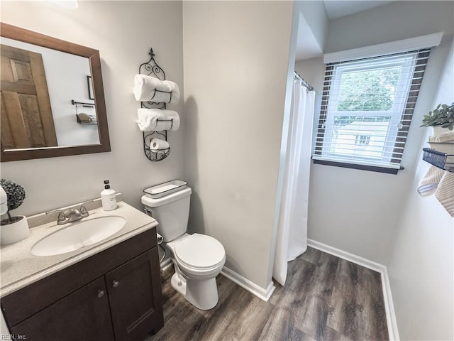 4657 Revere Dr, Virginia Beach, VA 23456 - bathroom featuring wood finished floors, vanity, toilet, baseboards, and curtained shower