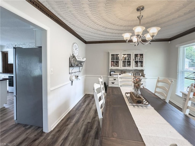 4657 Revere Dr, Virginia Beach, VA 23456 - dining room featuring dark wood-style flooring, a chandelier, ornamental molding, and baseboards