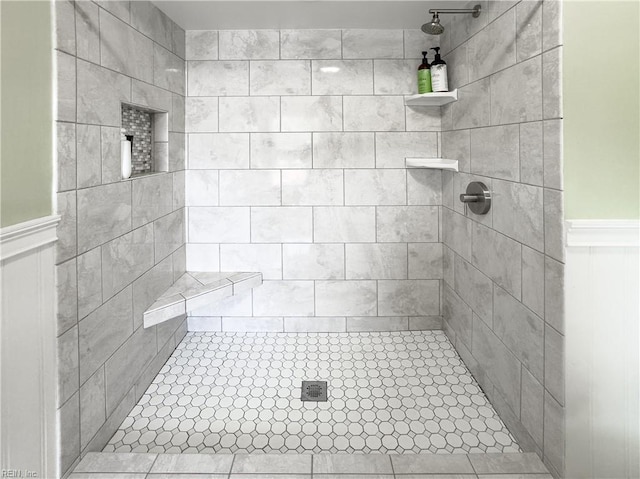 4657 Revere Dr, Virginia Beach, VA 23456 - bathroom featuring a tile shower and a wainscoted wall