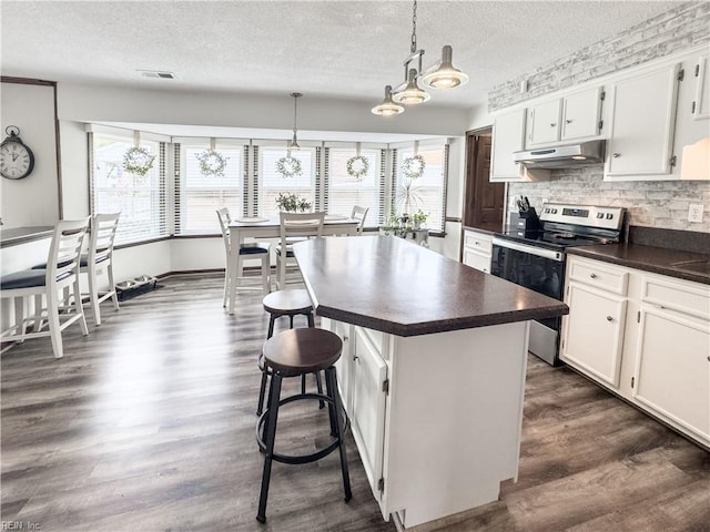 4657 Revere Dr, Virginia Beach, VA 23456 - kitchen with electric range oven, dark countertops, healthy amount of natural light, a textured ceiling, and backsplash