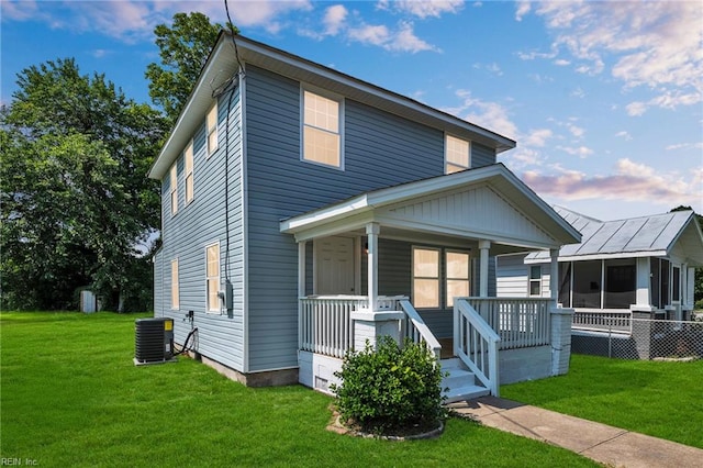 1604 Freeney Ave, Suffolk, VA 23434 - view of front of property with central air condition unit, a porch, and a front lawn