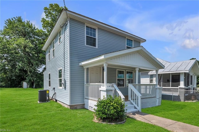 1604 Freeney Ave, Suffolk, VA 23434 - view of front facade featuring central AC, a porch, and a front yard
