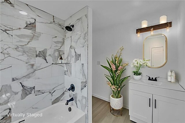 1604 Freeney Ave, Suffolk, VA 23434 - bathroom with vanity, tub / shower combination, wood finished floors, and baseboards