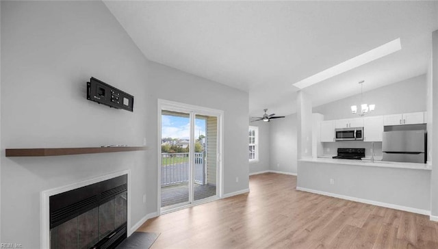 631 Bluff Ct, Virginia Beach, VA 23462 - unfurnished living room featuring lofted ceiling, a chandelier, a fireplace with flush hearth, wood finished floors, and baseboards