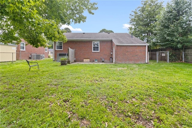 617 Redheart Dr, Hampton, VA 23666 - rear view of house with a fenced backyard, brick siding, and a patio