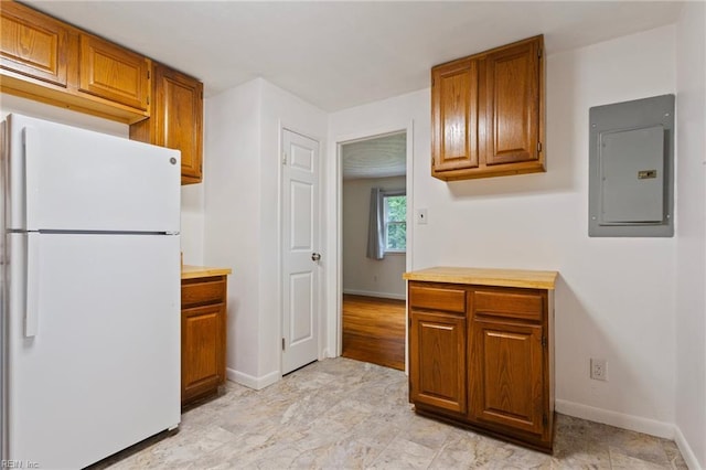 528 Murphys Mill Rd, Suffolk, VA 23434 - kitchen with freestanding refrigerator, electric panel, brown cabinets, and baseboards