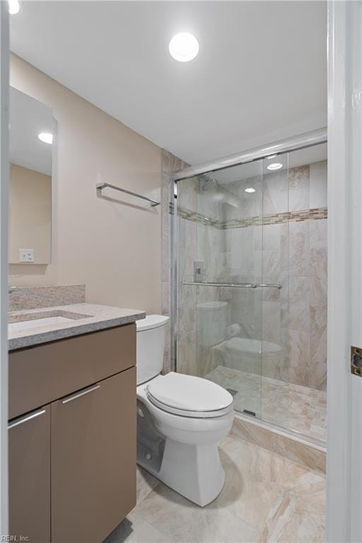 3810 Atlantic Ave Unit 304, Virginia Beach, VA 23451 - bathroom featuring vanity, toilet, a shower stall, and marble finish floors