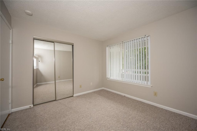 410 Babbling Brook Dr, Virginia Beach, VA 23462 - unfurnished bedroom with carpet flooring, a closet, baseboards, and a textured ceiling