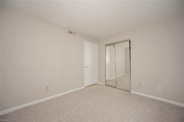 410 Babbling Brook Dr, Virginia Beach, VA 23462 - unfurnished bedroom with light carpet, baseboards, a textured ceiling, and a closet