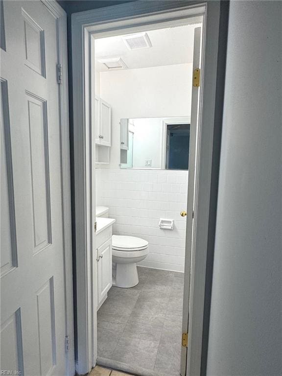 2 Yulee Ct, Hampton, VA 23669 - half bathroom with vanity, toilet, and tile walls