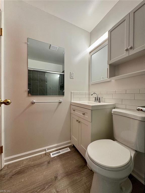 2 Yulee Ct, Hampton, VA 23669 - full bathroom with vanity, wood finished floors, toilet, baseboards, and a shower