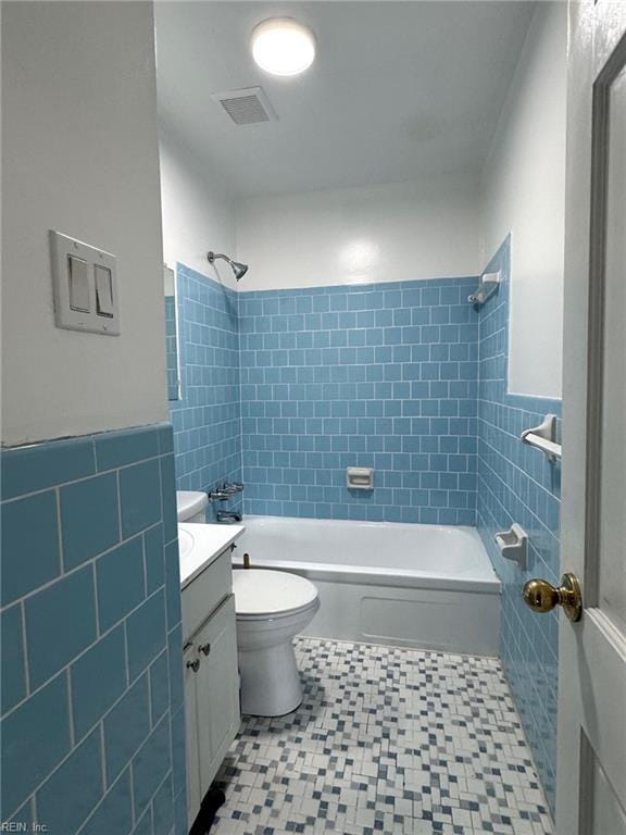 2 Yulee Ct, Hampton, VA 23669 - bathroom with tile walls, vanity, shower / bath combination, toilet, and tile patterned floors