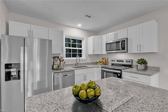 608 N Pine Grove Rd, Virginia Beach, VA 23452 - kitchen featuring stainless steel appliances, a sink, white cabinets, light stone counters, and recessed lighting