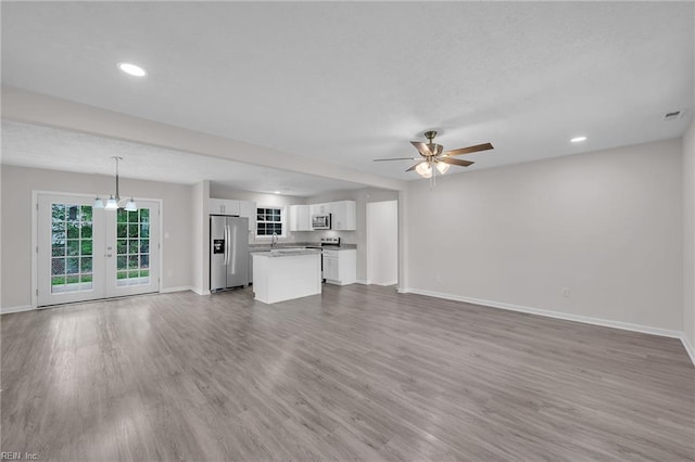 608 N Pine Grove Rd, Virginia Beach, VA 23452 - unfurnished living room featuring baseboards, french doors, wood finished floors, ceiling fan, and recessed lighting