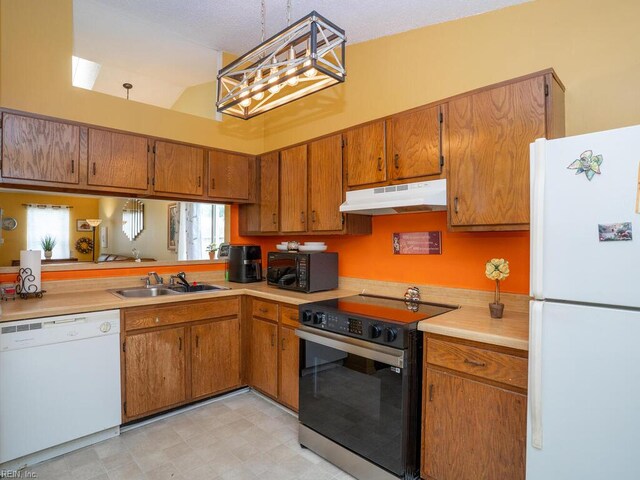 808 Dora Ct, Virginia Beach, VA 23455 - kitchen featuring black appliances, under cabinet range hood, brown cabinetry, a sink, and healthy amount of natural light