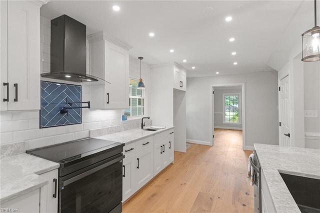 1756 Tyndall Point Rd, Gloucester Point, VA 23062 - kitchen with wall chimney range hood, black electric range oven, recessed lighting, white cabinets, and decorative backsplash