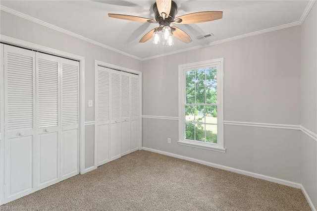 1756 Tyndall Point Rd, Gloucester Point, VA 23062 - unfurnished bedroom with multiple closets, carpet, baseboards, crown molding, and ceiling fan