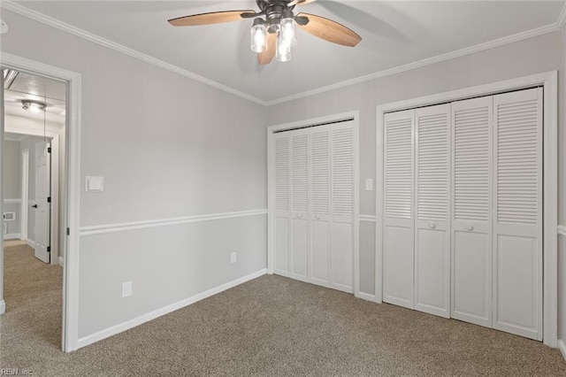 1756 Tyndall Point Rd, Gloucester Point, VA 23062 - unfurnished bedroom featuring carpet, two closets, ornamental molding, baseboards, and ceiling fan