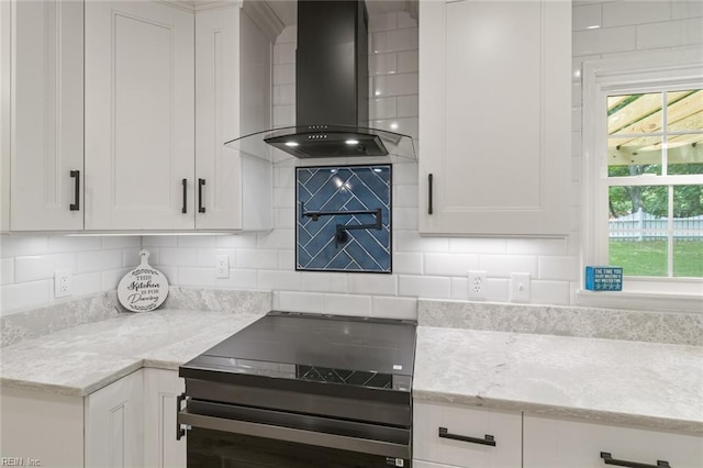 1756 Tyndall Point Rd, Gloucester Point, VA 23062 - kitchen featuring wall chimney range hood, plenty of natural light, white cabinets, and light stone counters