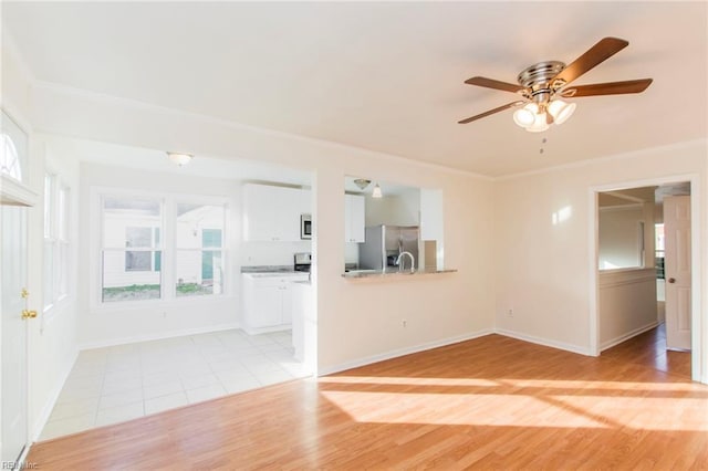 1582 Sword Dancer Dr, Virginia Beach, VA 23454 - unfurnished living room featuring plenty of natural light, a ceiling fan, crown molding, light wood-type flooring, and baseboards