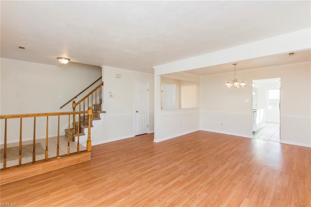 1582 Sword Dancer Dr, Virginia Beach, VA 23454 - unfurnished room featuring a chandelier, light wood finished floors, stairs, and baseboards