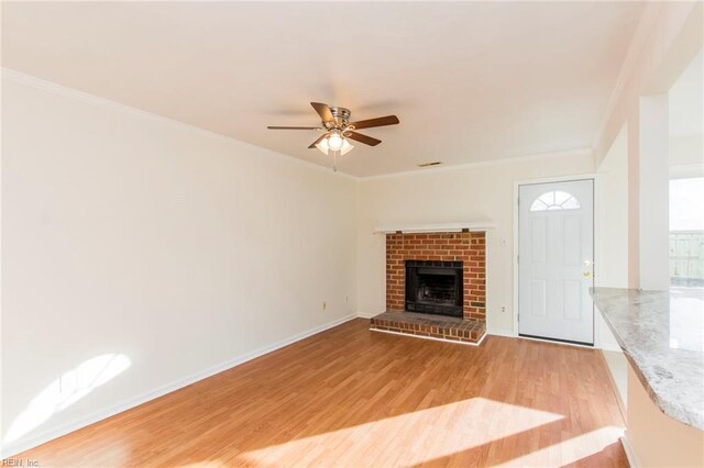 1582 Sword Dancer Dr, Virginia Beach, VA 23454 - unfurnished living room featuring light wood-type flooring, ceiling fan, ornamental molding, a brick fireplace, and baseboards