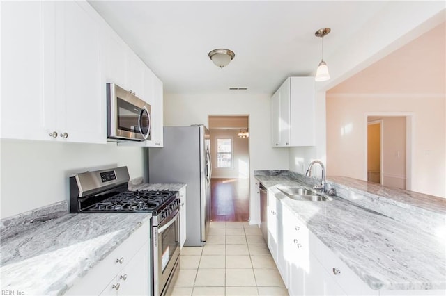 1582 Sword Dancer Dr, Virginia Beach, VA 23454 - kitchen featuring stainless steel appliances, a sink, a peninsula, white cabinetry, and light stone counters