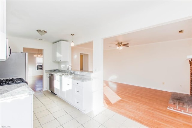 1582 Sword Dancer Dr, Virginia Beach, VA 23454 - kitchen with stainless steel dishwasher, white cabinets, stove, light tile patterned floors, and light stone counters