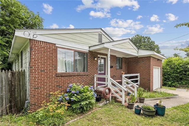 2306 Harrell Ave, Norfolk, VA 23509 - view of front of house with brick siding, an attached garage, and driveway