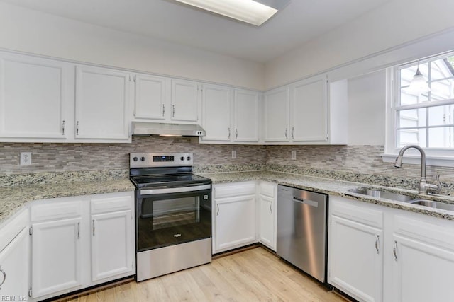 1603 Skiffes Creek Cir, Williamsburg, VA 23185 - kitchen with stainless steel appliances, a sink, extractor fan, white cabinets, and backsplash