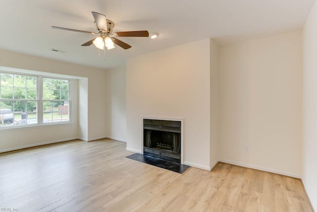 1603 Skiffes Creek Cir, Williamsburg, VA 23185 - unfurnished living room featuring wood finished floors, ceiling fan, baseboards, and a fireplace with flush hearth