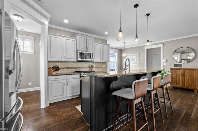 624 Mill Creek Pkwy, Chesapeake, VA 23323 - kitchen with appliances with stainless steel finishes, crown molding, dark wood-style flooring, an island with sink, and stone countertops