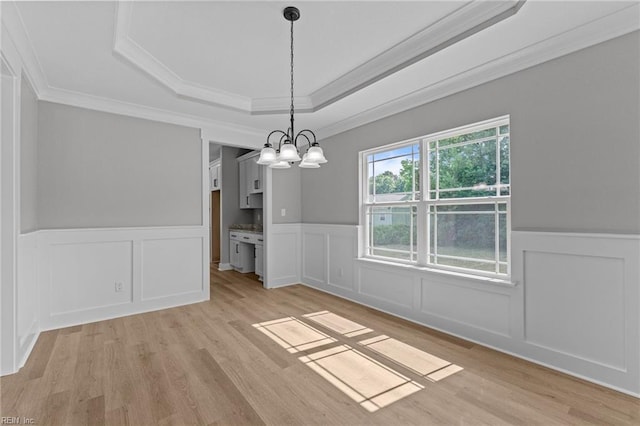 4 Roundtree Cir, Hampton, VA 23661 - unfurnished dining area featuring a tray ceiling, a wainscoted wall, ornamental molding, light wood-style flooring, and a decorative wall