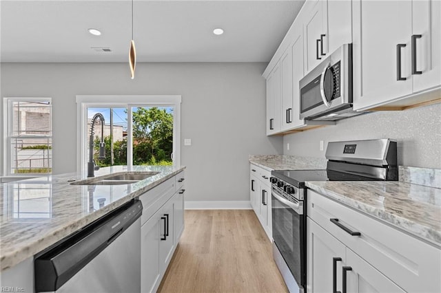 4 Roundtree Cir, Hampton, VA 23661 - kitchen with stainless steel appliances, light wood finished floors, light stone countertops, white cabinetry, and recessed lighting